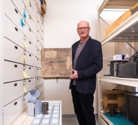 Curator David Seubert holding Moellendorff Collection materials